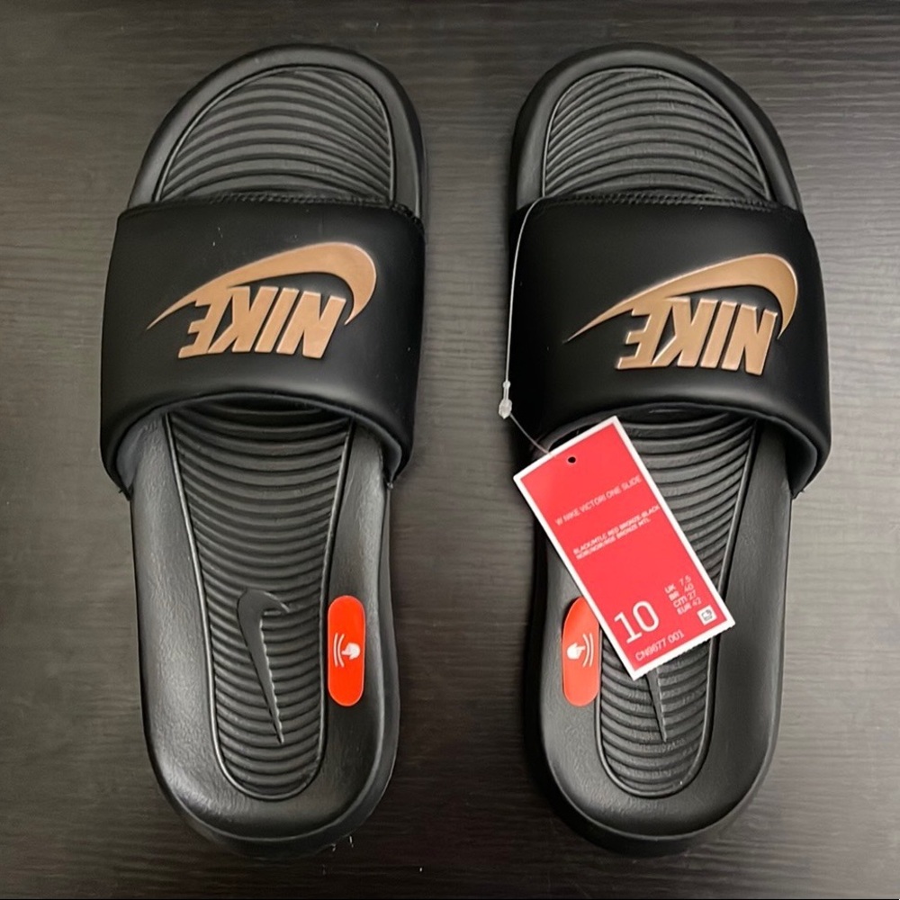 Rose gold and Black Nike slides. Size 10 in Womens.